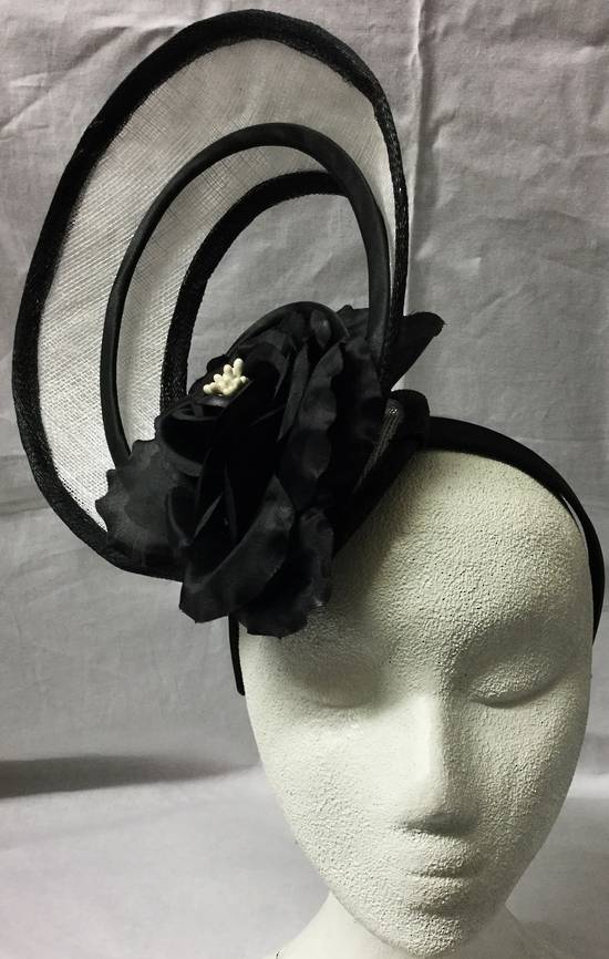 White and black fascinator with cut aways and flower - one only