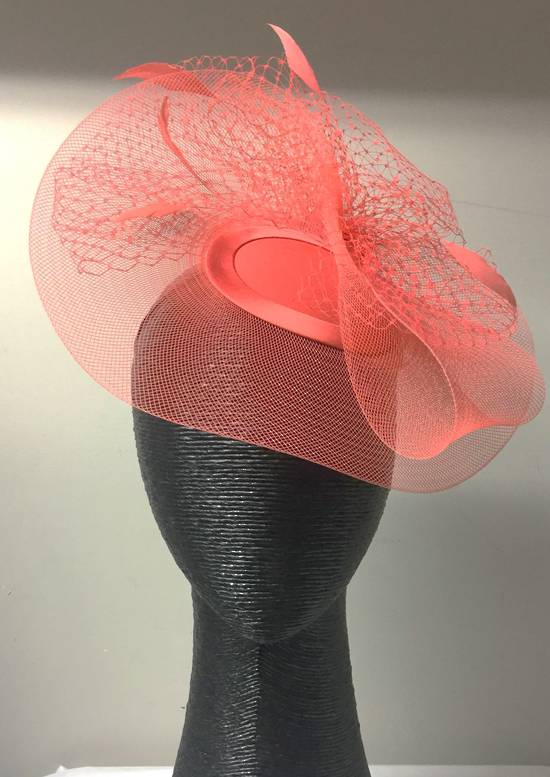 Coral cocktail hat with veiling and feathers